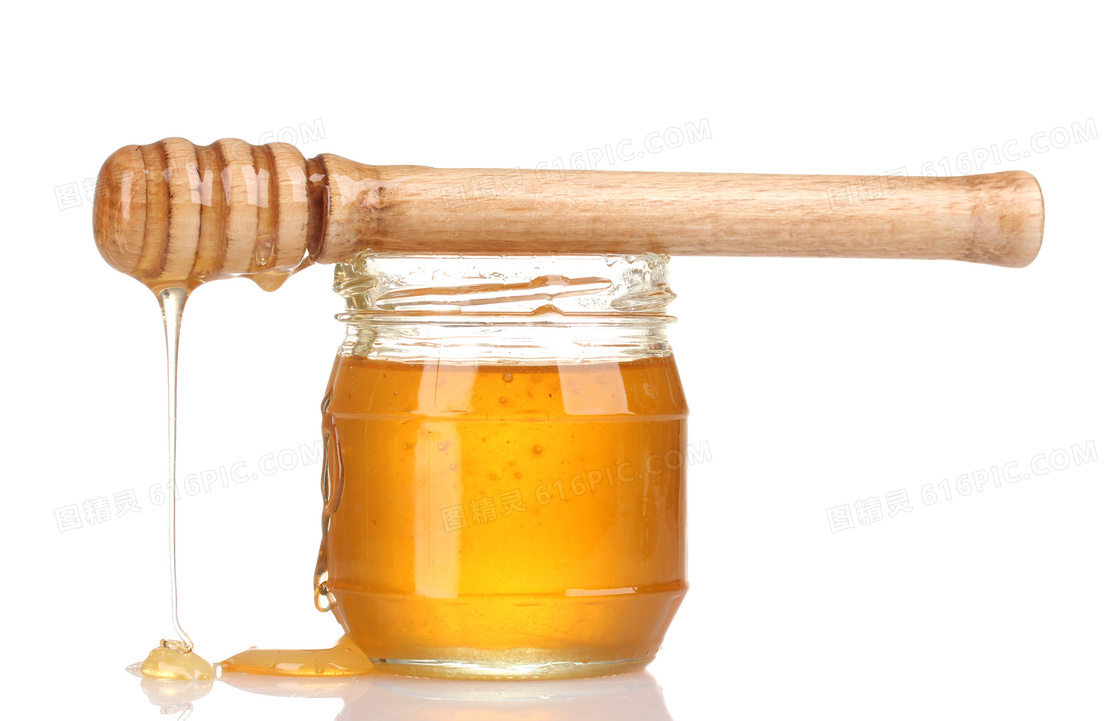 搅拌棒与在玻璃罐里的蜂蜜高清图片