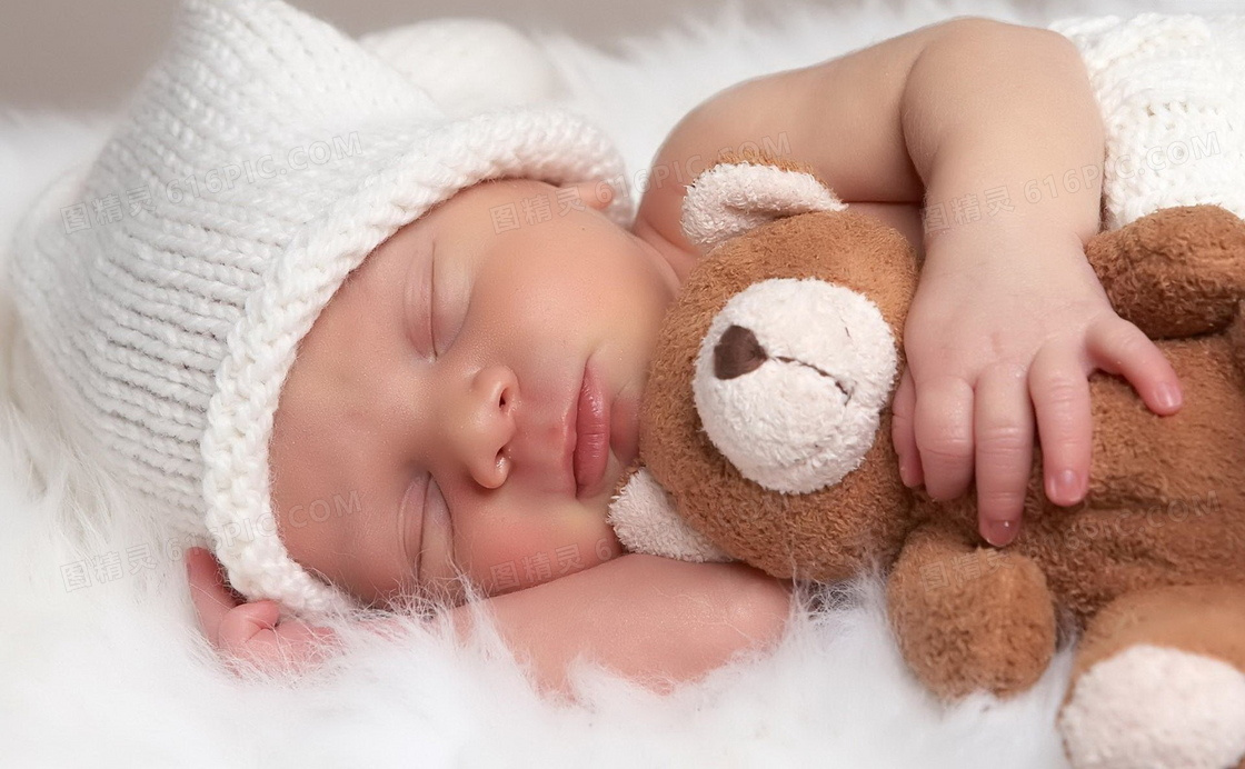 怀里抱着玩具熊睡觉的宝宝摄影图片