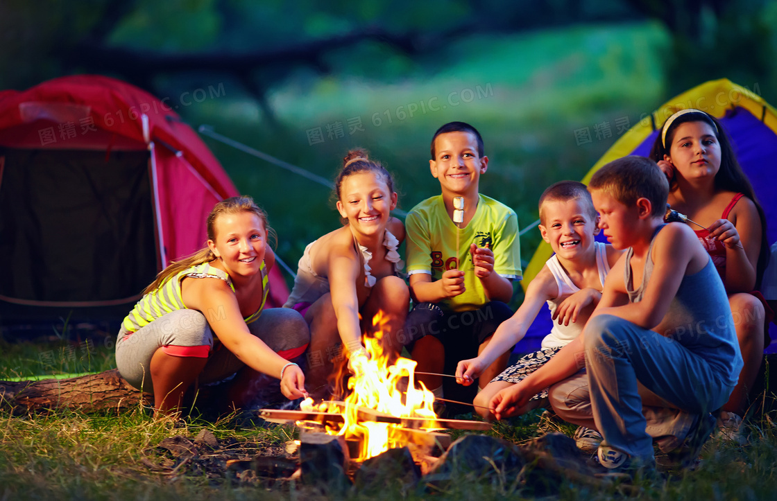 围着篝火吃烧烤的孩子摄影高清图片